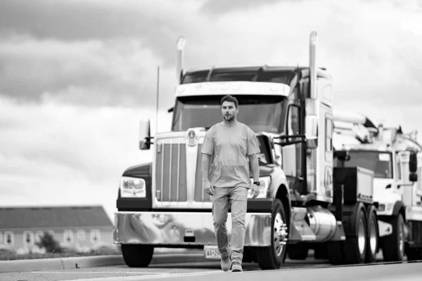 truck driver represents logistics. truck driver shows concept of logistics. truck driver represents logistics walking outdoor. photo of truck driver with logistics concept.