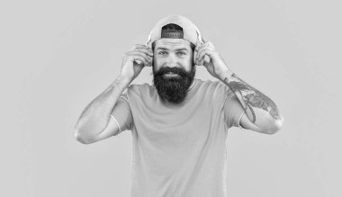 Müzik kulaklıklı olumlu bir adamın fotoğrafı. Müzik kulaklıklı adam sarıda izole edilmiş. Stüdyoda müzik kulaklıklı bir adam. Arka planda müzik kulaklığı olan adam..
