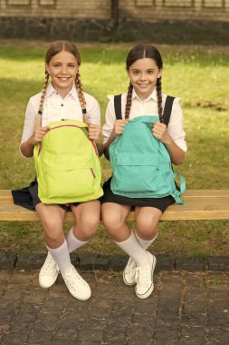 back to school. two happy teen children after school with backpack. friendship of school girls.