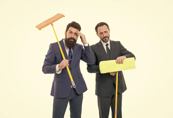 businessmen clear wall to white. clean slate. Partnership and teamwork. cleaning company. clean business. mature bearded men in suit hold householding mop. they have clean slate. clean slate concept.