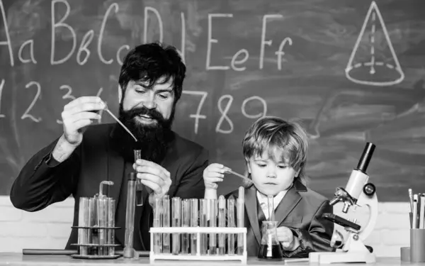 teacher man with little boy. Biology Science lab. Scientist research and experiments Back to school. father and son at school. learning chemistry in school laboratory. Science is always the solution.