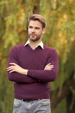 confident young handsome man in casual style crossed hands outdoor.