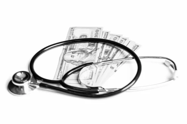 stock image medicine expenses concept. charity savings. money for medicine expenses in selective focus. stethoscope of medicine expenses isolated on white background. photo of medicine expenses currency.