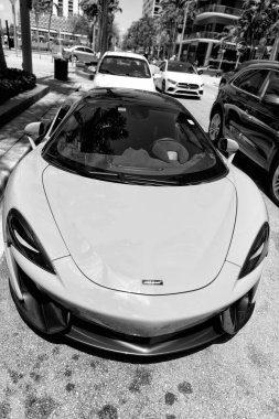Miami Beach, Florida USA - April 15, 2021: white mclaren 570s convertible sportcar, front view.