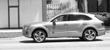 Miami Beach, Florida USA - April 15, 2021: pink metallic Bentley Bentayga v8 2015 suv, side view.