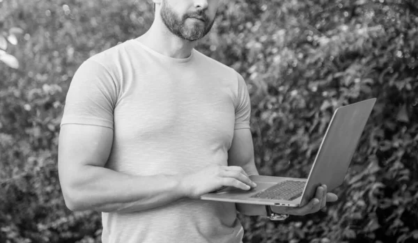 stock image cropped view of freelancer man outdoor. freelancer man work online. photo of freelancer man freelancing. freelancer man with laptop.