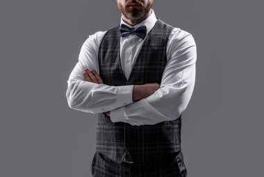 cropped view of confident tuxedo man in formalwear with bowtie. tuxedo man in formalwear isolated on grey background. tuxedo man in formalwear at studio. tuxedo man wear formalwear fashion.