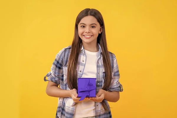 teen girl with present. teen girl holding present box with excitement at birthday party. teen girl holding a present. teen girl show present on a special occasion. exchange gifts.