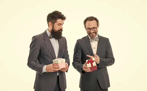 happy birthday shopping. business partners on meeting isolated on white. businessmen in formal suit on party. success and reward. esthete. bearded men hold valentines present. Pleasant shopping.