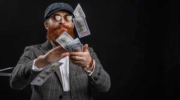 Man spending money isolated on black. Englishman with money. Rich man in retro suit. Copy space. Gentleman has successful business. Man with casino money. Bearded man businessman. Rich Englishman.