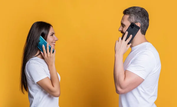 Couple having phone conversation. Distance relationship. Family couple talk on phone. Modern communication technology. Man and woman speak on phone. Family connected in distance. Voicemail.