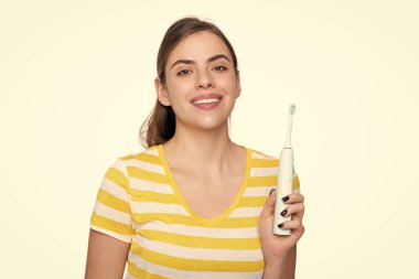 happy woman with electric toothbrush isolated on white background.