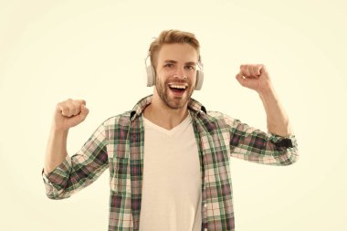 Mutlu adam beyaz stüdyoda izole edilmiş müzikten hoşlanır. Tasasız adam kulaklıkla müzik dinliyor. Gülümseyen adam neşeli müziğe jestler yaparak eğleniyor..