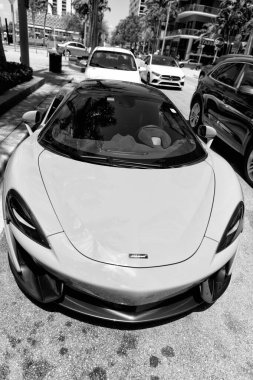 Miami Beach, Florida USA - April 15, 2021: white mclaren 570s convertible sportcar, front view.