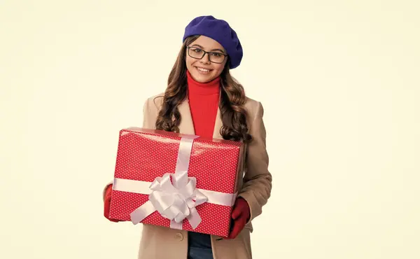 teen girl hold present isolated on white background. teen girl hold present in studio. holiday mood of teen girl holding present. photo of stylish teen girl with present.
