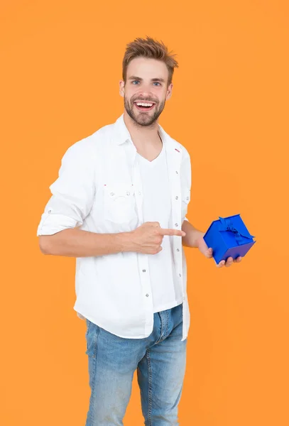 smiling man with present in studio. man with present on background. photo of man with present box. man with present isolated on white.