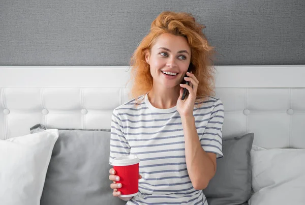happy woman with coffee speak on phone. woman at home speaking on phone. speaking on phone woman at home.