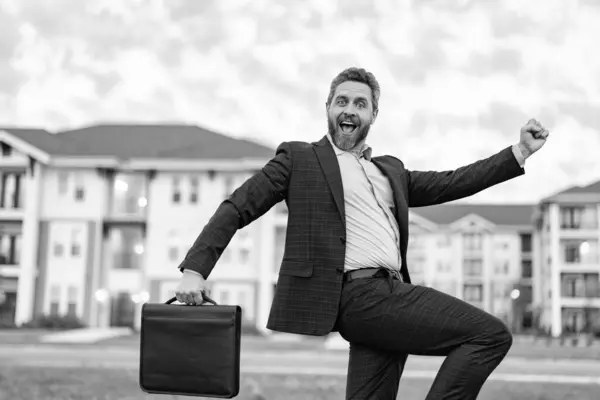 surprised real estate business man with briefcase. real estate business man outdoor. photo of real estate business man. real estate business man.
