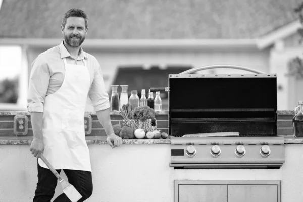 stock image man grilling salmon fillet, advertisement. man grilling salmon fillet outdoor. man grilling salmon fillet at backyard. photo of man grilling salmon fillet for barbecue.