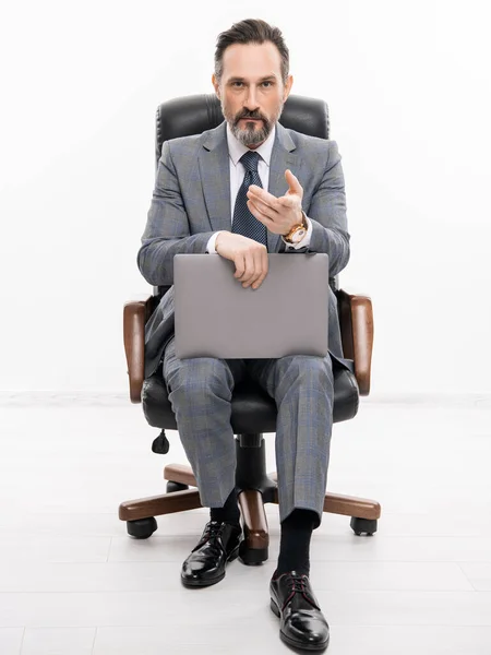 Businessman using laptop isolated on white. freelancer working online. Man has online blog. Businessman in suit with laptop in office chair. Remote online working. Business blog success. freelancing.