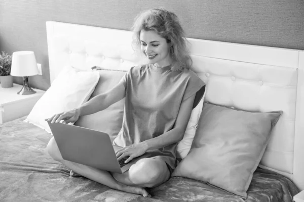 woman freelancer work at home on laptop. freelancer woman work at home. home work for freelancer. woman smile in bed with laptop.