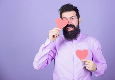 Celebrate love. Guy attractive with beard and mustache in romantic mood. Feeling love. Dating and relations concept. Falling in love. Happy in love. Man bearded hipster with heart valentine card.