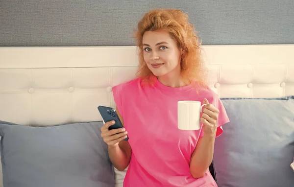 woman with coffee chat on phone. woman chat at home with phone. phone chat at home of woman.