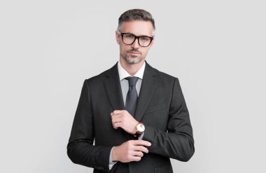 mature boss in formal suit with eyeglasses and wristwatch.