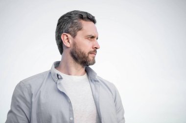 pensive man portrait standing peaceful. pensive man in shirt outdoor. pensive man on sky background.