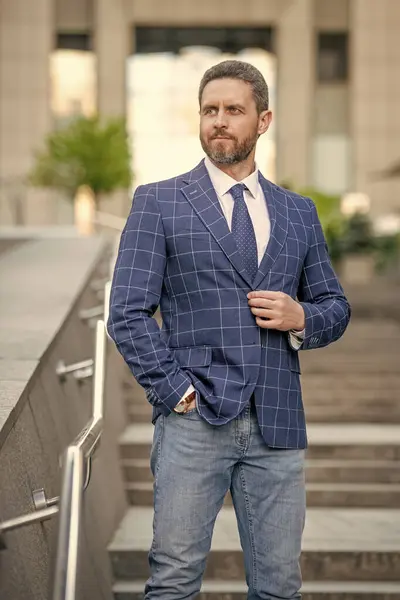 adult businessman outdoor. businessman in jacket. caucasian businessman standing outside. professional businessman in formalwear.
