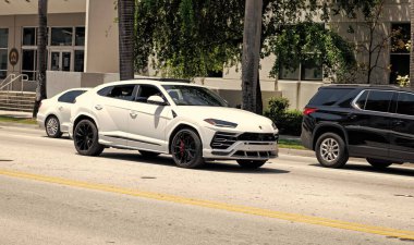 Miami Beach, Florida USA - April 15, 2021: 2019 white Giallo Auge Lamborghini Urus, corner view.
