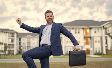 Pozitif emlak işçisi. Evrak çantalı emlakçı. Dışarıdaki emlakçı. Gayrimenkul işçisi fotoğrafı..