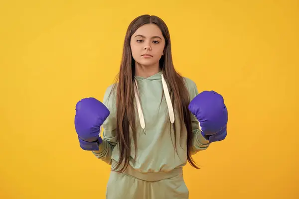 Teen boxer training with discipline and determination. teen girl in boxing goves. boxing training of teen girl. girl learn punching. teen defense. girl sport training. sport active wear. boxing match.