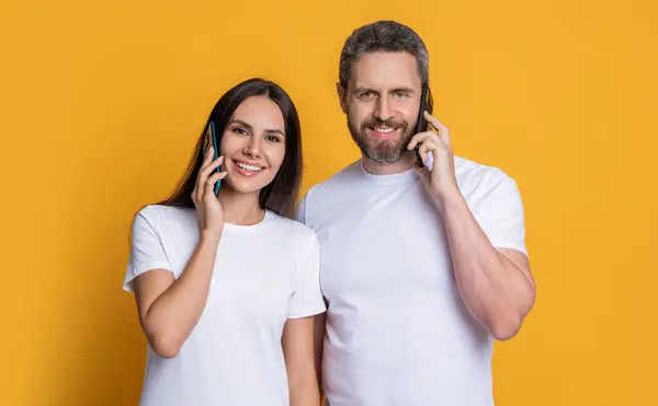Couple having phone conversation. Distance relationship. Family couple talk on phone. Modern communication technology. Man and woman speak on phone. Family connected in distance.