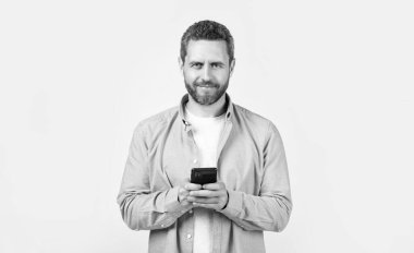 Stüdyoda mesajı olan mutlu bir adam. Erkek telefonundan mesaj var. Mesaj atan adamın fotoğrafı var. Stüdyo arka planına izole edilmiş bir şekilde telefonla mesaj yaz..