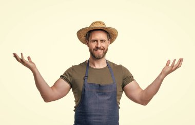happy man in hat and apron gesturing isolated on white background.