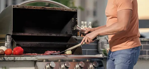 Grilling man cook meat at barbecue. Outdoor man cooking grill and barbecue dishes. Savvy grill connoisseur. Man grilling steaks to perfection on smoky barbecue. onglet steak.