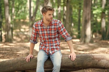 young handsome guy in checkered shirt relax outdoor.