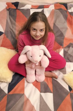 childhood of teen girl relax wearing pajama holding toy. childhood of teen girl relax. childhood of teen girl relax in bed. childhood of teen girl relax in bedroom.