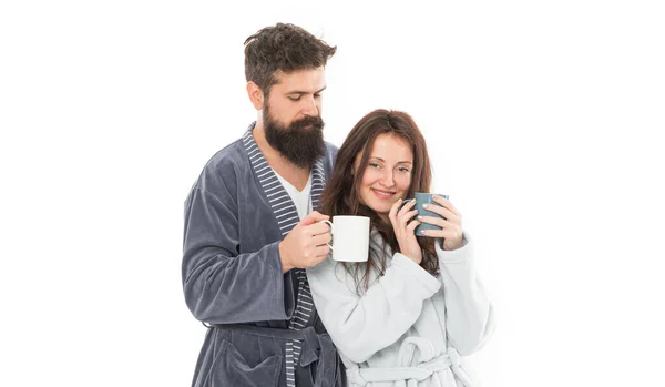 Caffeine power concept. With coffee morning tastes better. Couple relax in morning with coffee. Couple enjoy lazy weekend and drink coffee. Wife and husband bathrobes hold tea mug coffee cup.
