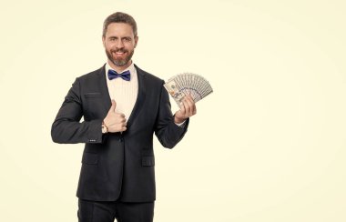 rich man in tuxedo with money isolated on white background with copy space. rich man hold money in studio. rich man won jackpot money. rich man millionaire having money banknotes.