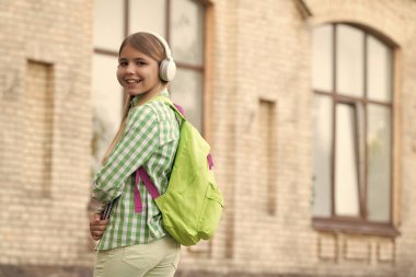 school education of teen girl outside, copy space. school education of teen girl in the street. photo of school education of teen girl with backpack. school education of teen girl outdoor.