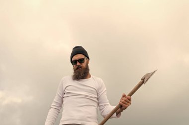 bearded man lumberjack with axe or ax. photo of bearded man lumberjack holding axe in the mountain. bearded man lumberjack hold axe outdoor. bearded man lumberjack has axe.