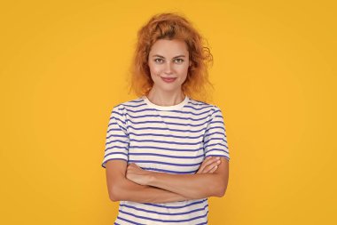 smiling redhead woman portrait isolated on yellow background. portrait of young redhead woman in studio. adult redhead woman portrait.