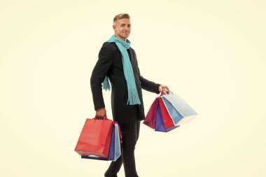 positive shopping man with purchase isolated on white. shopping man with purchase in studio. shopping man with purchase on background. photo of shopping man with purchase.
