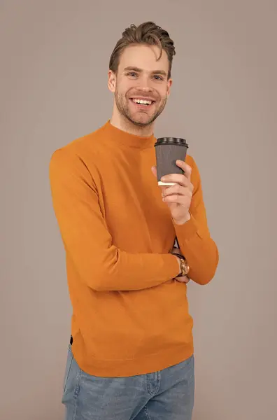 photo of happy guy at coffee break. guy at coffee break isolated on grey background. guy at coffee break in studio. guy at coffee break hold cup.