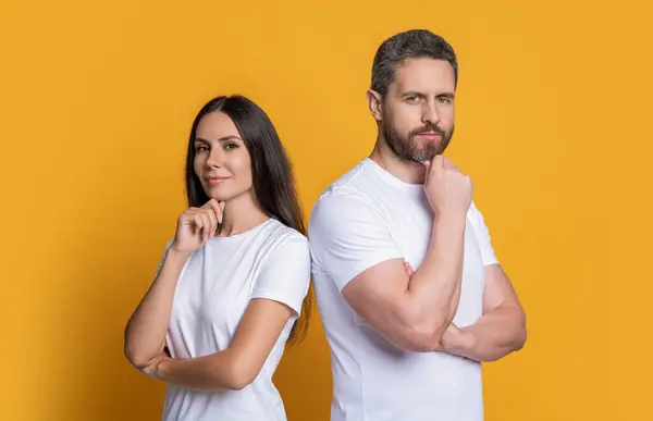 Millennial couple with casual style. Two friends. Family couple. Couple of millennial man and woman isolated on yellow. Man and woman in white tshirt. Family portrait. Interpersonal relations.
