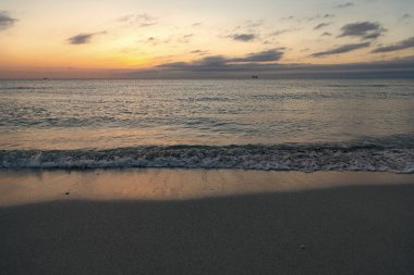 beautiful sundown with sea water on the summer beach.