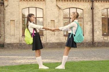 two girls friends having fun together outdoor. back to school.