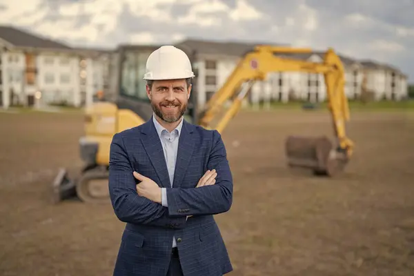 photo of construction business owner wearing hardhat, advertisement. construction business owner in suit. construction business owner at site. construction business owner outdoor.